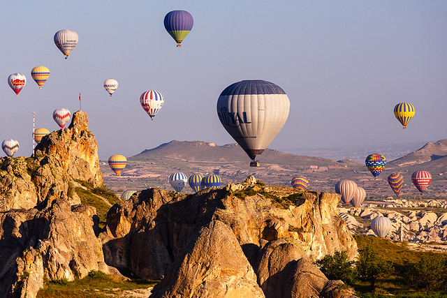 Hot air balloons flying over Cappadocia's rocks, Turkey