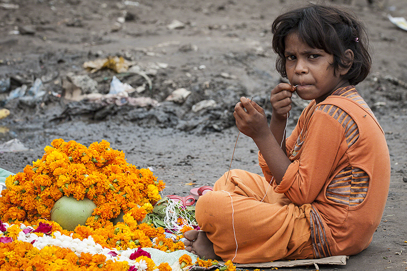 #23 Children Lives. Young street worker produces sacred necklaces ... | Ballabgher Village | India
