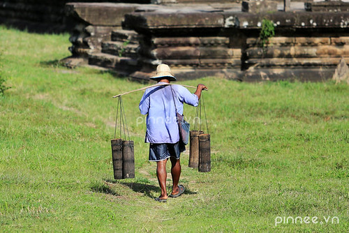 A Cambodian man carries Palm juice drink