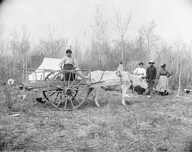 A Métis family at their camp with a Red River Cart in Manitoba / Une famille métisse à son campement avec une charrette de la rivière Rouge au Manitoba
