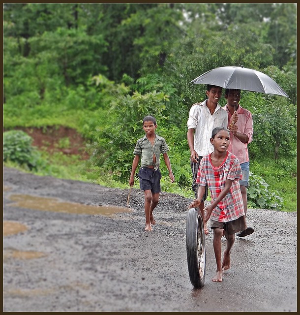Monsoon scene in rural Thane - What's he doing with that motorbike wheel?