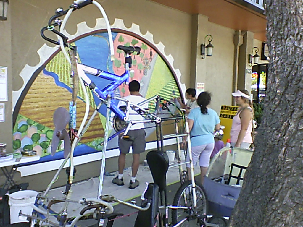Bike trike Tallie & small ditto on mural (@2:00)