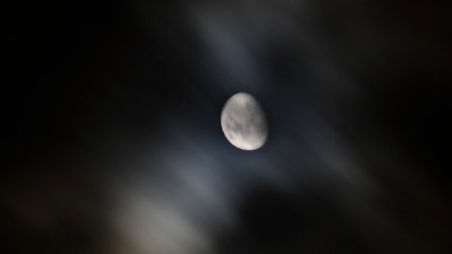 Waxing moon through the clouds