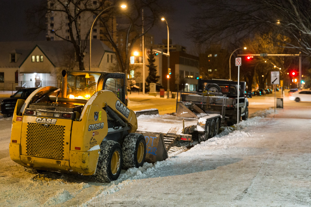 Machines involved in snow and ice control in Edmonton parked on the street