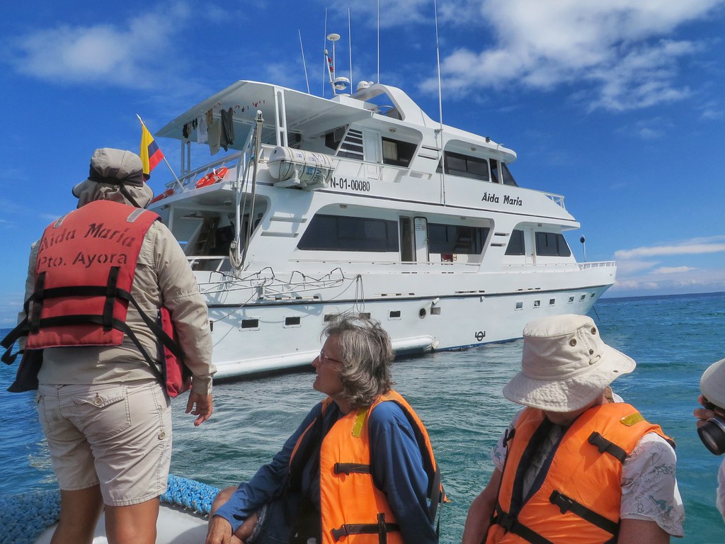 A group of women in life jackets reach the Aida Maria boat in the Galapagos islands, Ecuador