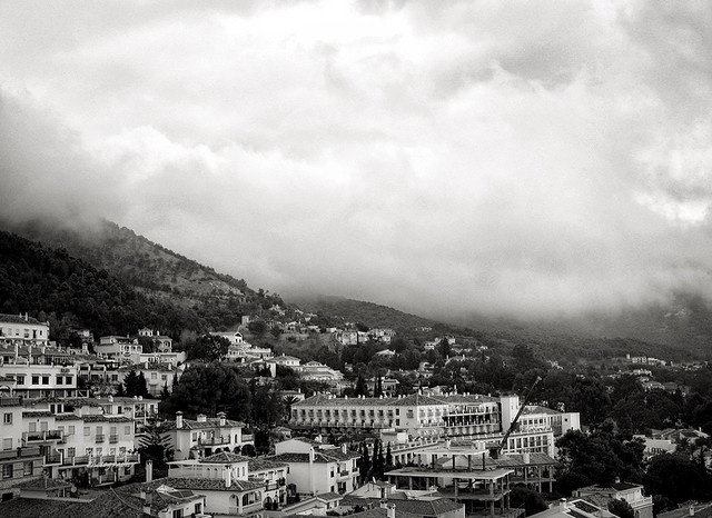 mist over snow-white mountain village on the hills of Mijas