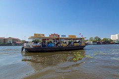 Ferry over the Chao Phraya river from Tha Thien pier to Wat Arun, the temple of dawn, in Bangkok, Thailand