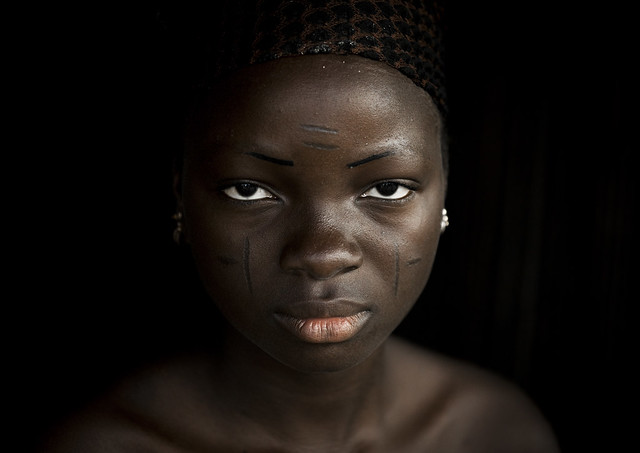 Benin, West Africa, Onigbolo Isaba, holi tribe woman covered with traditional facial tattoos and scars portrait