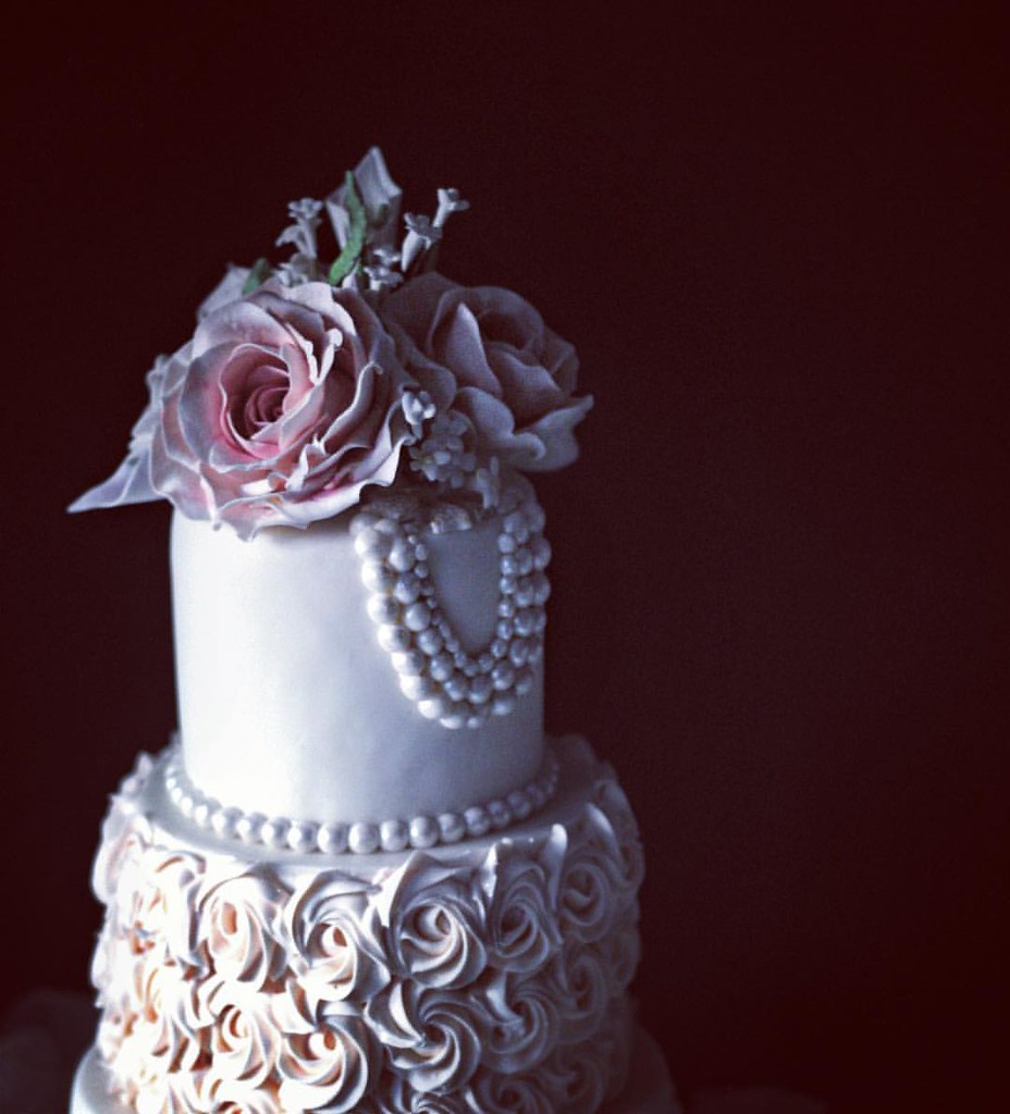 Wedding cake details. #sugarroses #pink #rosettes #weddingcake #chicagobride #loyolauniversitychicago #pearls #romantic #chicagofood #wedding #weddinggift #babushkabakery