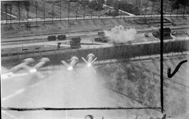 Still from film shot by a Hawker Typhoon of No. 181 Squadron RAF while attacking trucks in railways sidings at Nordhorn, Germany, showing a salvo of 60-lb rocket projectiles heading for the target, which has already been hit.