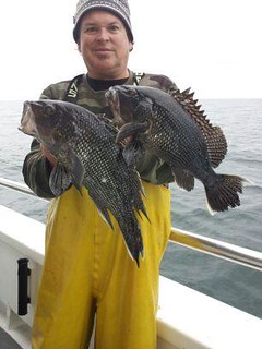 Photo of man holding black sea bass