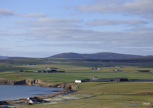 overlooking elevatedviewpoint scapa maltwhisky distillery seaside coastline scapabay calm blue sea low cliffs distinctive large building warehouses adjacent scapaflow rural farmland farms fields houses stola parish orquilburn mouth white water distant skyline heather covered orphirhills big sky skyscape thin clouds cloudscape sunny february winter sunshine nearkirkwall largesttown orkney islands scotland uk greatbritain orcades interesting view elevated outlook scenery attractive landscape