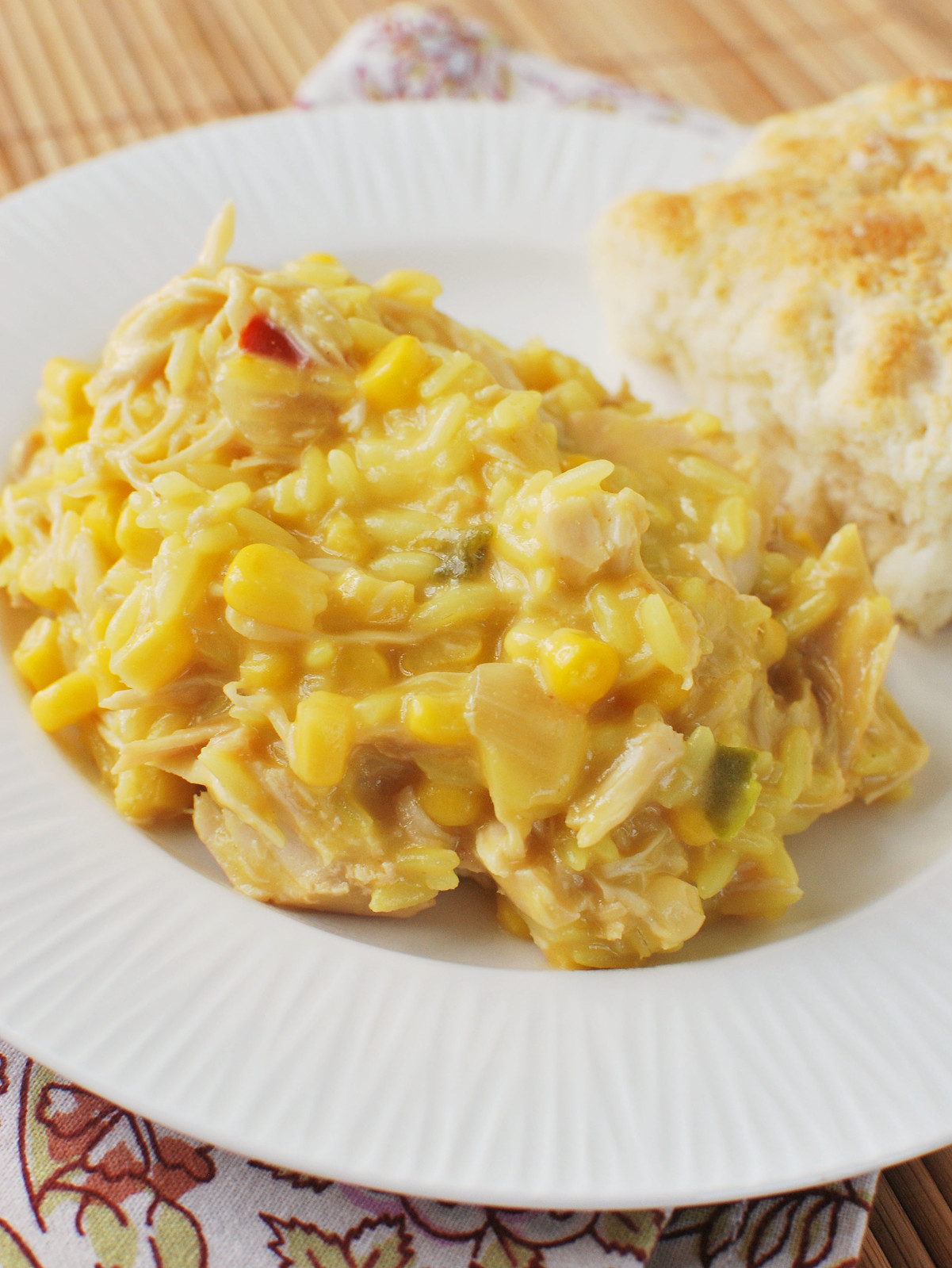 Chicken with yellow rice, cheese, and corn. 