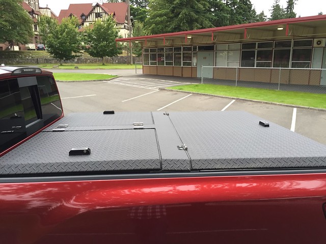 An Aluminum Truck Bed Cover On A Nissan Titan