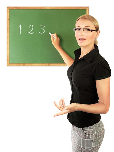 young-teacher-writing-numbers-on-the-chalkboard-isolated-on-white-background- | by www.ilmicrofono.it