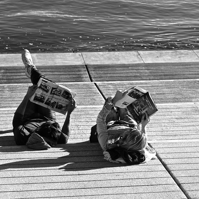 Couple reading the news on a sunny afternoon