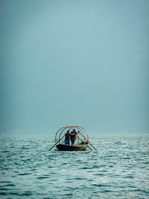 Hommes en barque sur le Lac de Côme