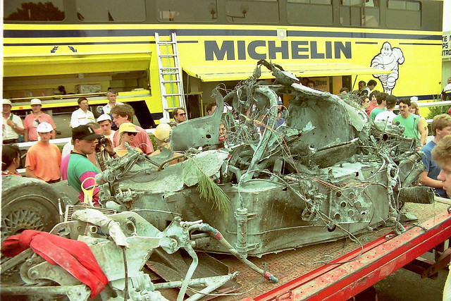 Accident and fire damaged car, possibly a Lancia LC2SP90, brought back to the pits at the 1990 Le Mans
