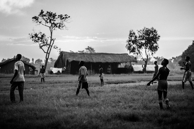 Lendu men playing football at sunset - Democratic Republic of the Congo -