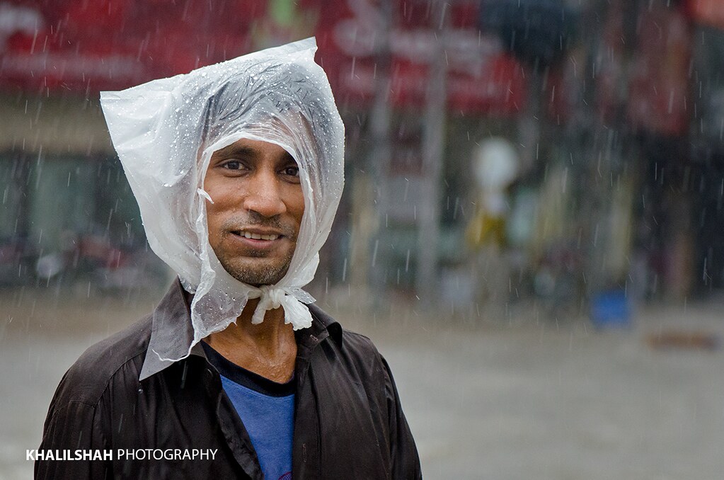 A man cover his head with plastic bag to shield himself Flickr