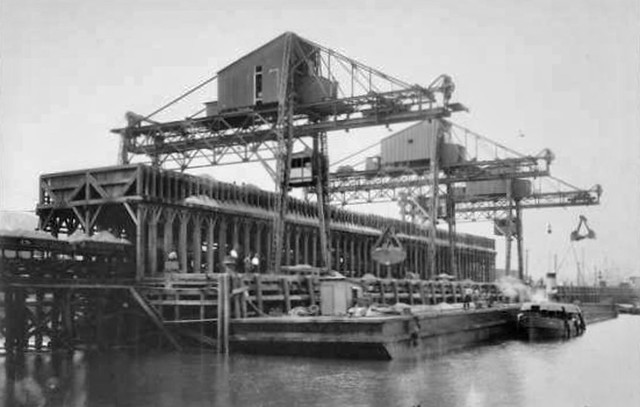 PanamaCanal- Cranes Moving Sand from Barge to Train in Balboa (1912)