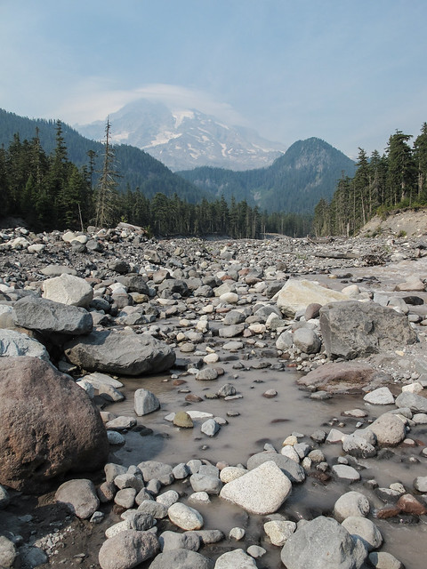 Distant Mount Rainier and the gray waters of the Nisqually River, during a condition of wildfire smoke.