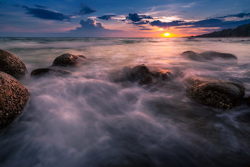ocean light sunset sea sun seascape rock seaside sand wave boulder