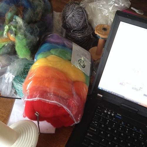 The current state of things. A rare day in with exhausted kids and rain. I'm thinking some carding and fiber prep for future #tdf spinning. #ontheround #tdf2014 #tourdefleece2014 #rainbow #fiberprep #fiberartist #etsy #etsysellers #behindthescenes #wahm | by ontheroundfiberart