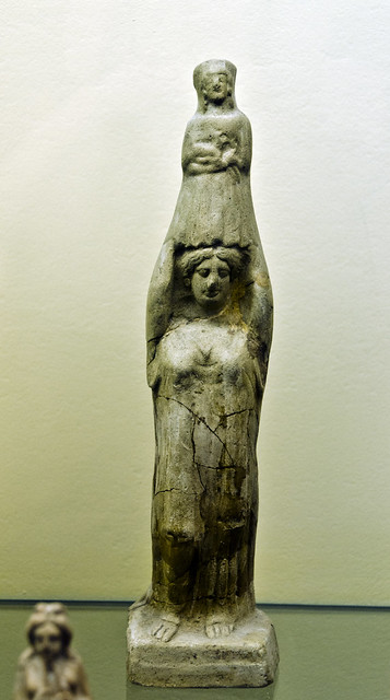 Miniature terracotta figure of a woman carrying an image of Artemis on her head
