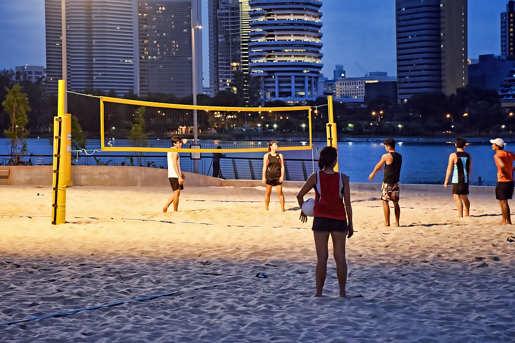 Group of friends at a beach volleyball court near Singapore Sports Hub