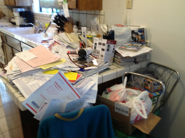 Kitchen counter covered in junk mail
