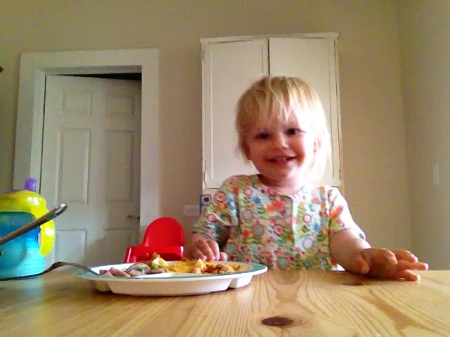Zoe eating dinner . camera is upside down