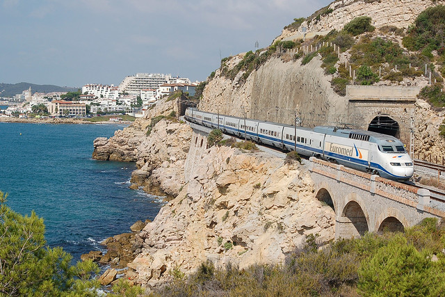 S101-trainset operating Euromed 1282 to Barcelona Sants on 26 August 2009 with Sitges in the background
