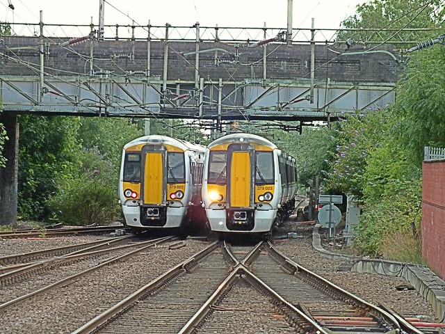 One in, one out. Greater Anglia 379 002 departs Broxbourne, with a Cambridge - Stratford service, as 379 023 approaches with a Liverpool St - Cambridge working. 13 07 2014