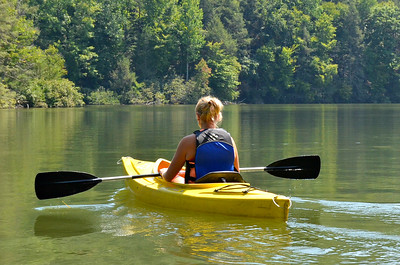 photo of kayaker on lake