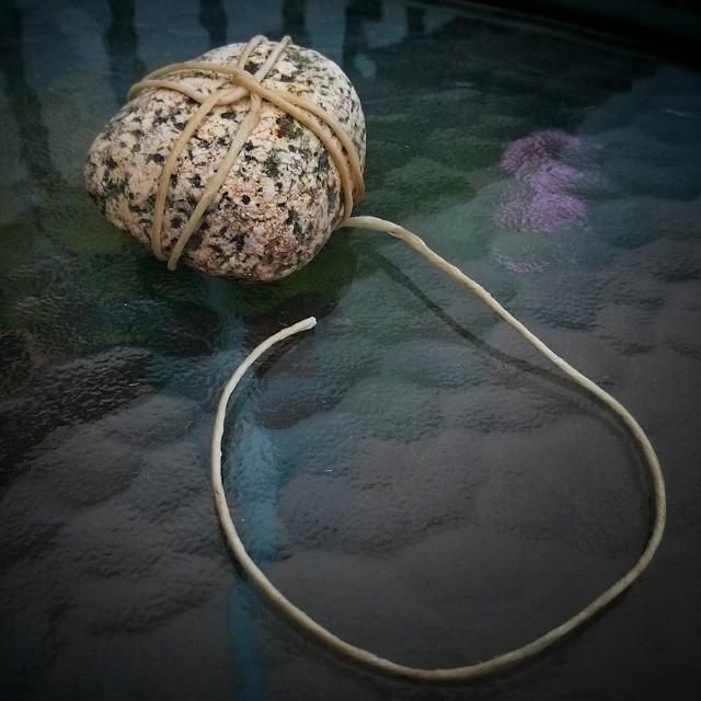 tied some string around a stone, put it on the table.