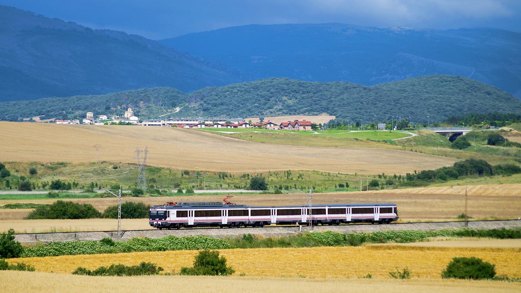 Regional passenger train crossing open countryside