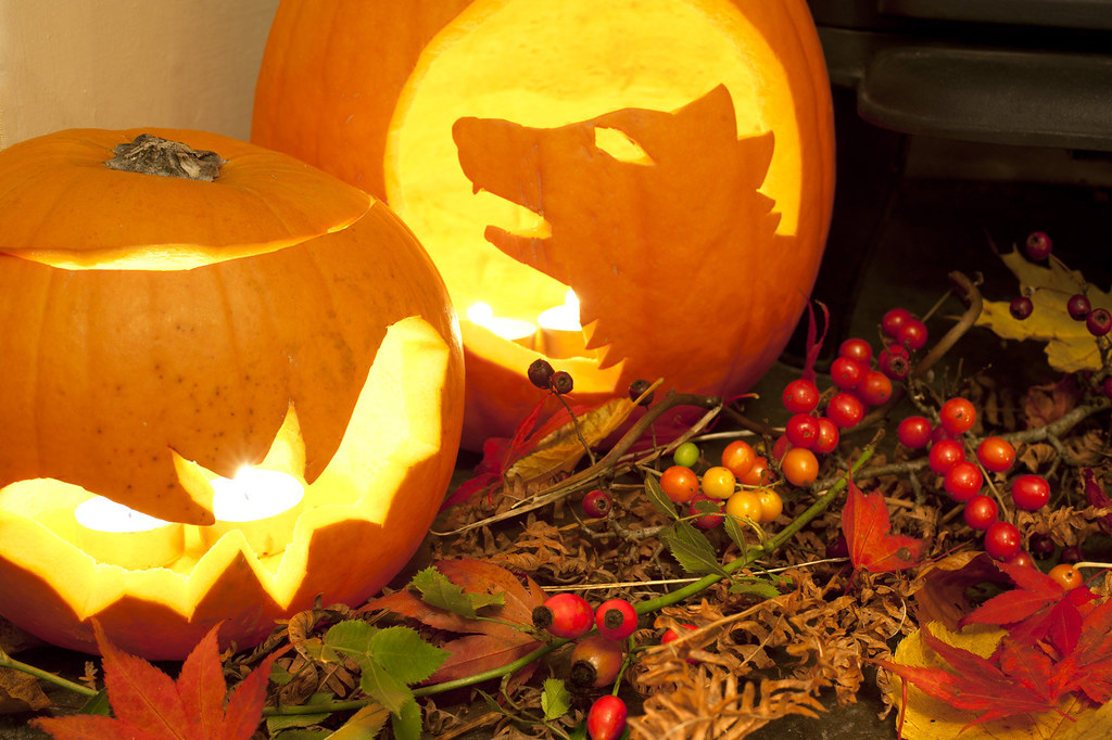 Two glowing Halloween lanterns lit by candles