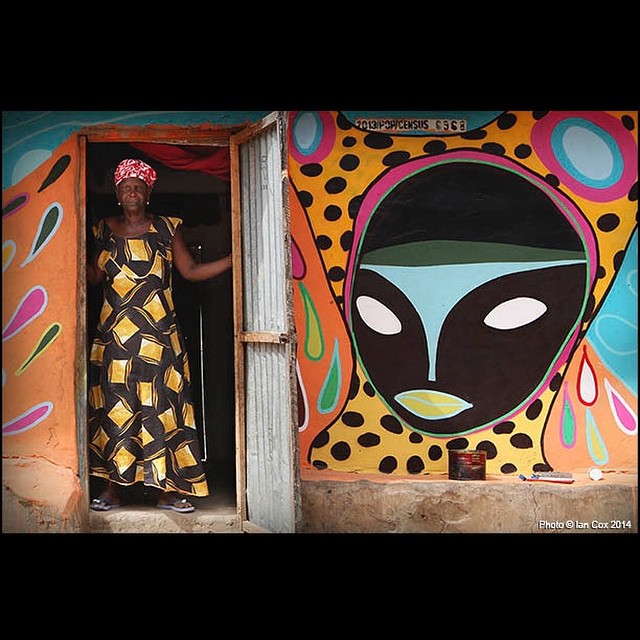 'Dressed for the Occasion'. @rimonguimaraes vibrant work at home with the people of #Galloya village #Gambia for the @wideopenwalls project. #wallkandy #streetart #graffiti #art #painting #africa #fb #f #t @churchofbestever @remirough