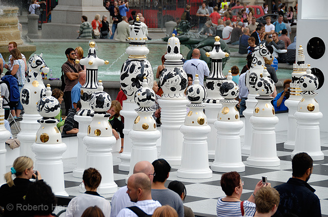 Giant chess pieces in Trafalgar Square, London, England. The Tournament, an installation created by Spanish designer, Jaime Hayón consists of a gigantic chess set, with 2m high ceramic pieces designed by Hayón on a specially created mosaic glass board. Th