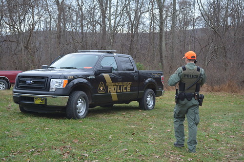 Photo of Natural Resources Police officer and vehicle in field