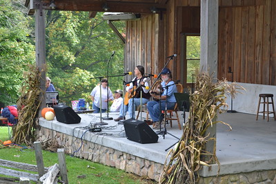 photo of folk band playing music on a stage