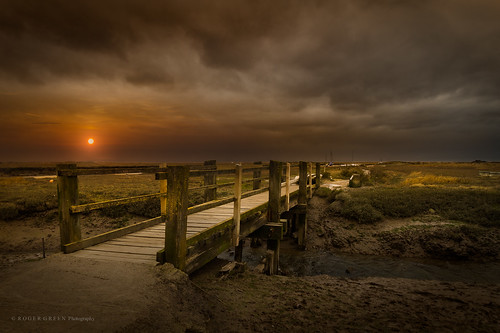 blakeney norfolk uk wind sun sunset bridge marsh coast clouds