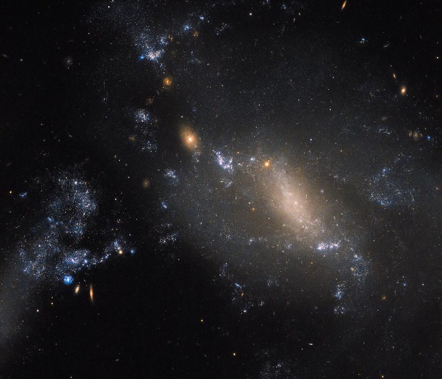 Hubble Sees NGC 3447: 2 Galaxies in a Cosmic Dance Defy Conventions