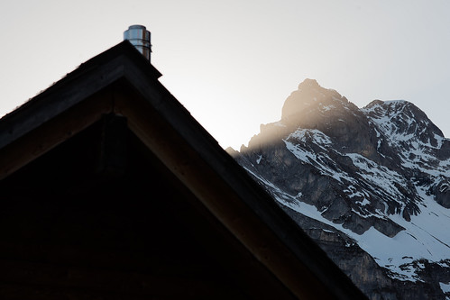 roof light sunset sun snow mountains stone schweiz switzerland twins rocks glare gable linthal