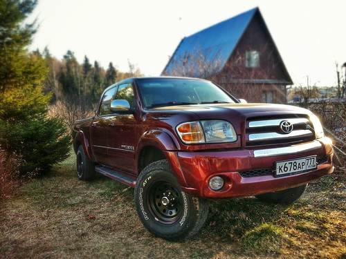 Red Toyota Tundra in front of barn