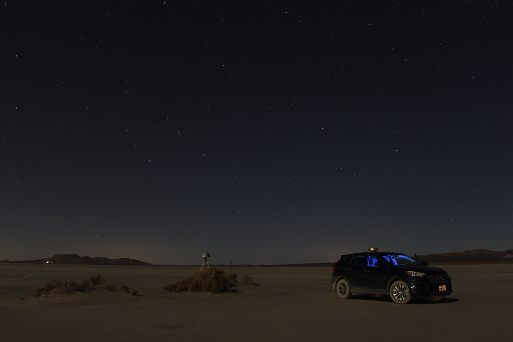 Vehicle on a flat landscape under a dark sky