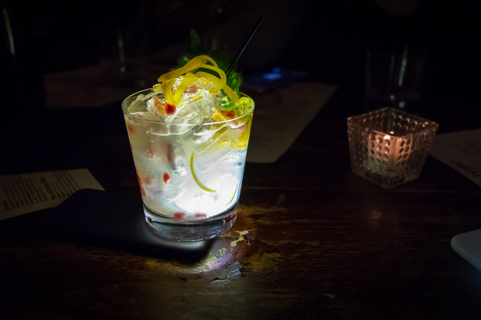 a bright and lemony cocktail, garnished with a shiso leaf