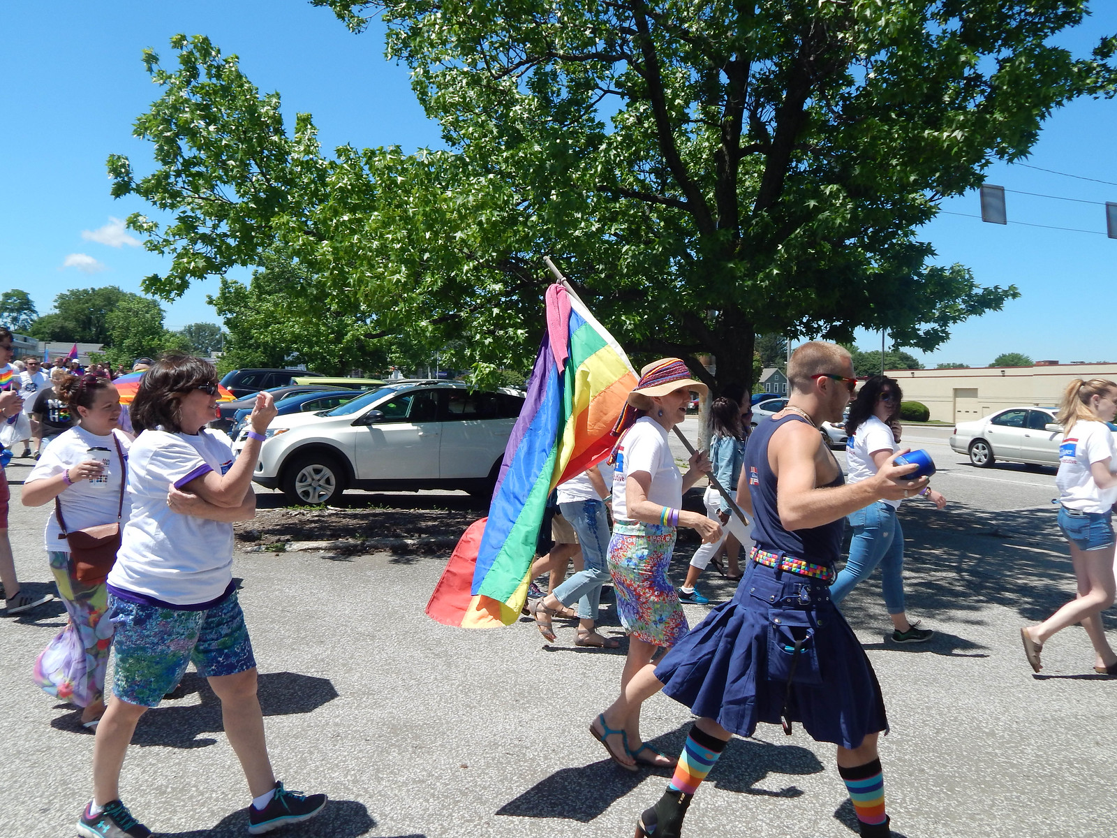 Kathy Dahlkemper carrying rainbow flag next to her son Nate