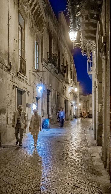 Polished flagstones gleam in the streetlights of via Leonardo Prato in Lecce, Italy
